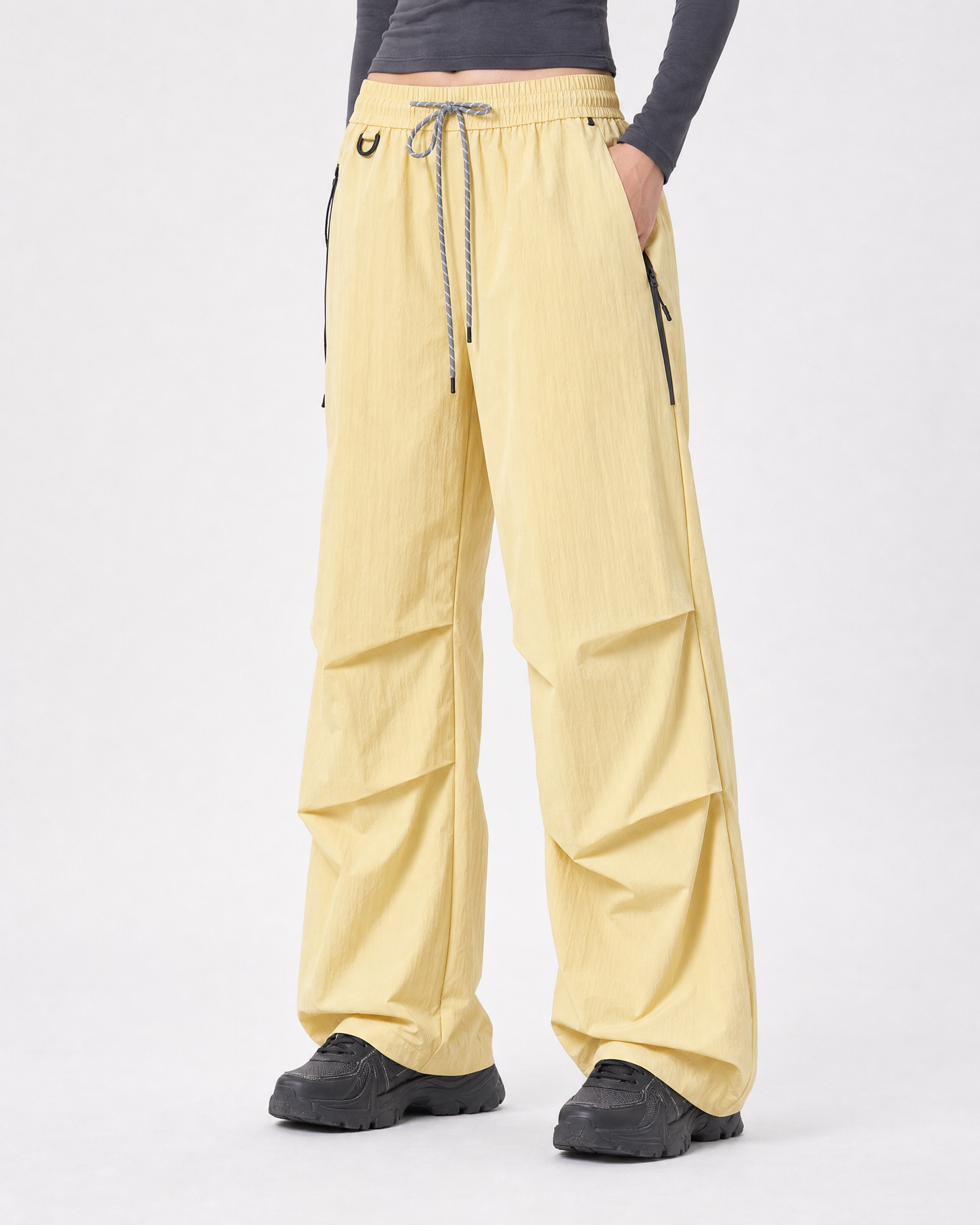 Women's water-repellent hiking trousers in yellow, relaxed hand in pocket # Colour_Yellow